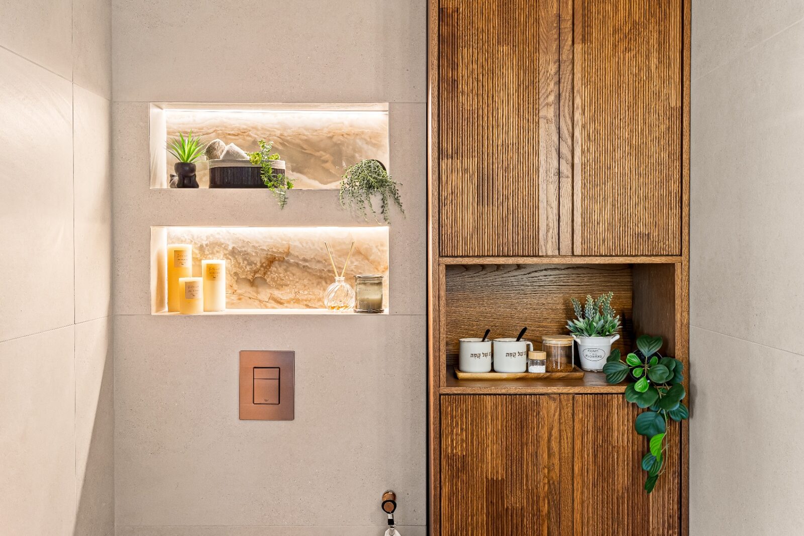 Rishon LeZion bathroom detail with backlit onyx niches and fluted wood storage