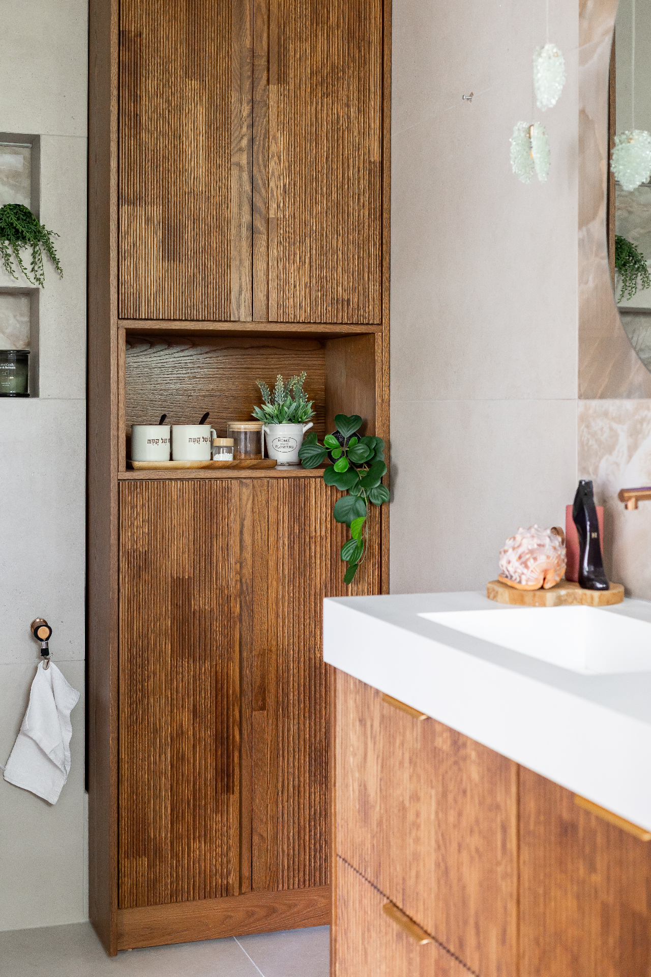 Rishon LeZion bathroom storage cabinet detail with fluted wood joinery and vanity edge