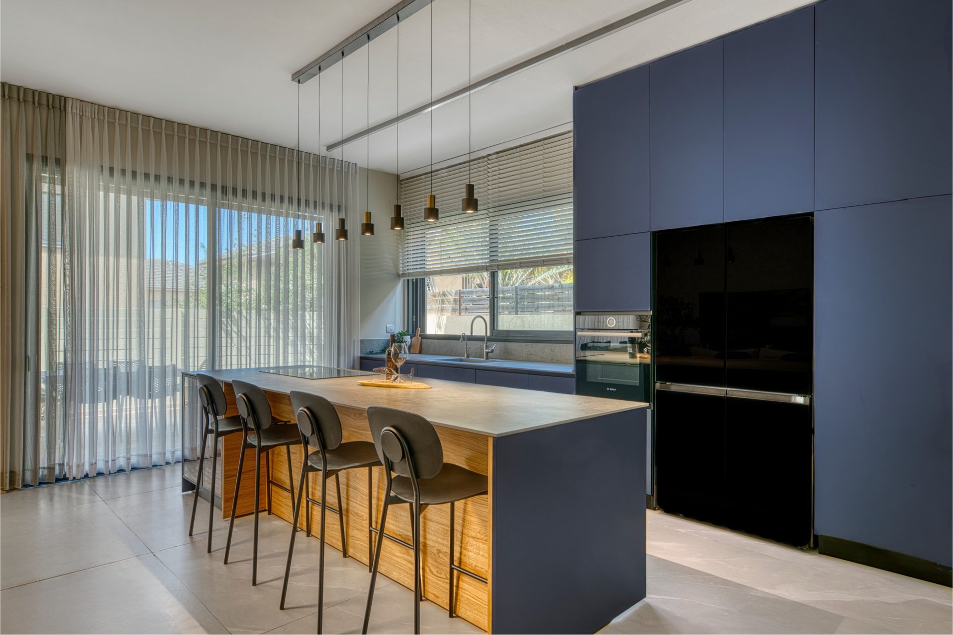Gedera kitchen island with bar seating and pendant lights