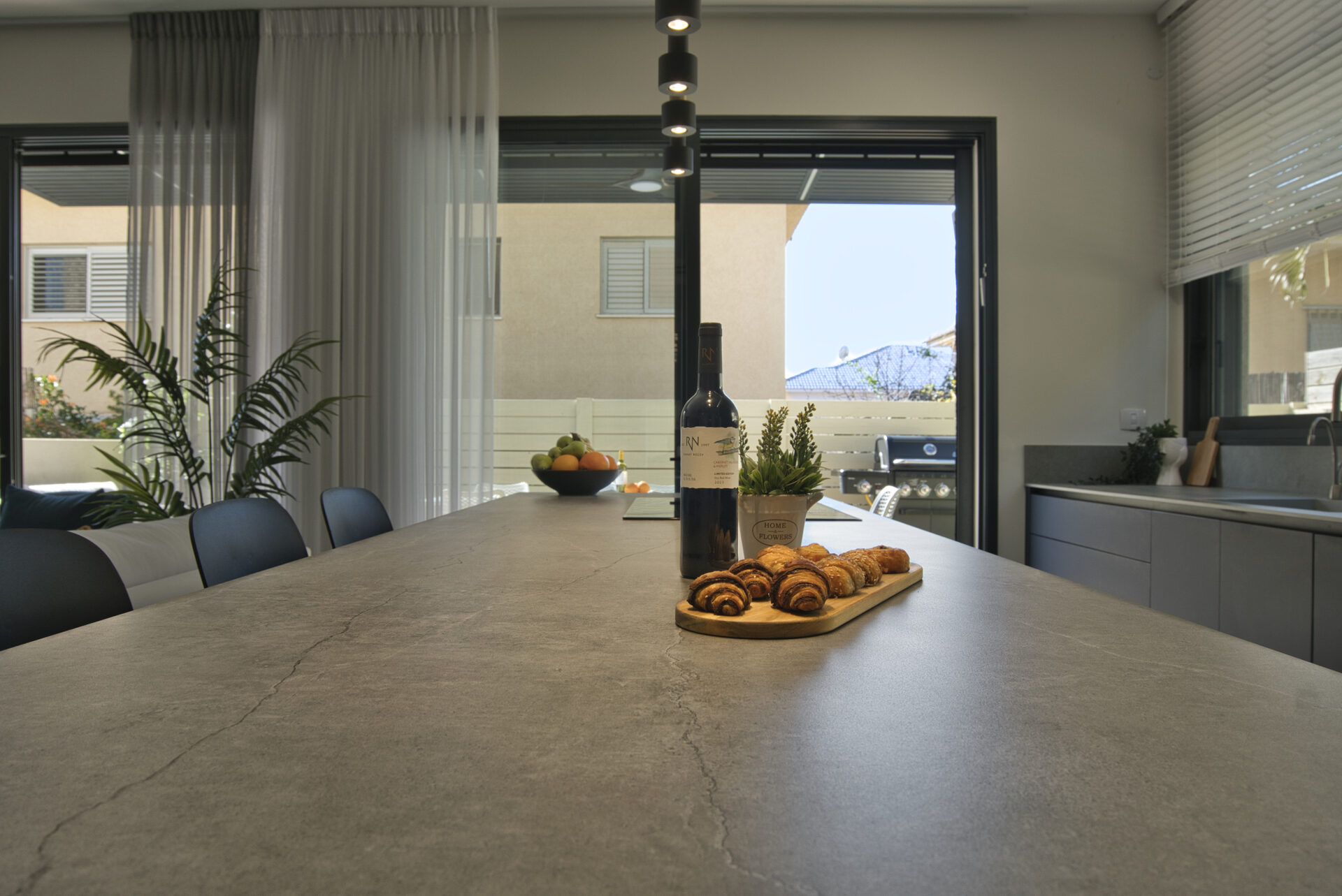 Gedera kitchen island stone countertop styled with wine and pastries