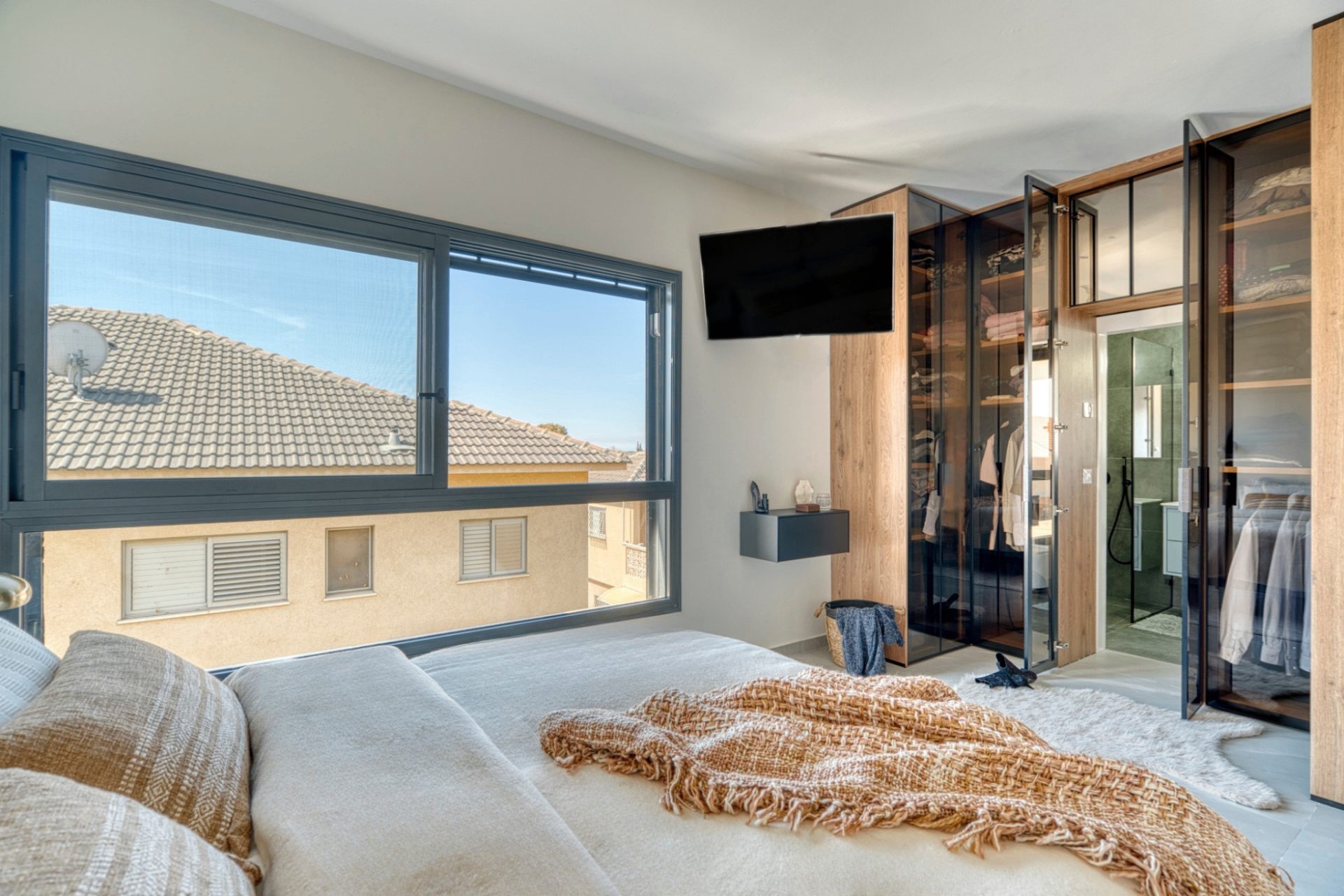 Rishon LeZion bedroom with glass closet and ensuite view